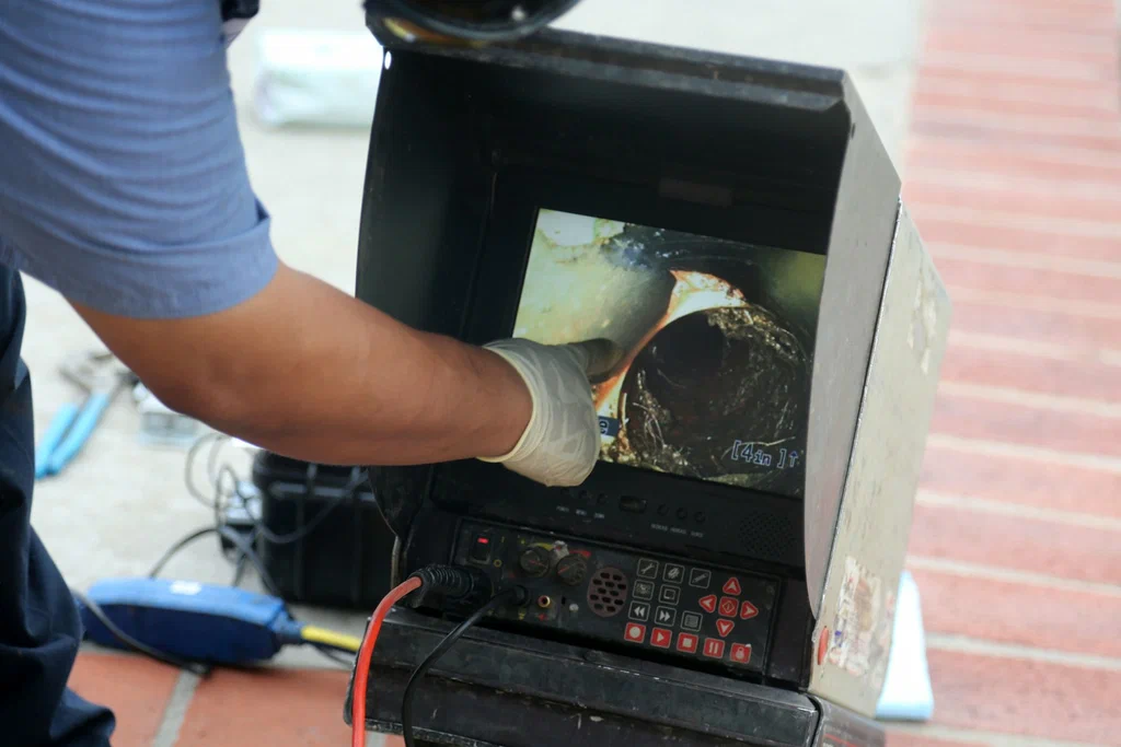 Technician viewing a drain inspection camera in La Quinta
