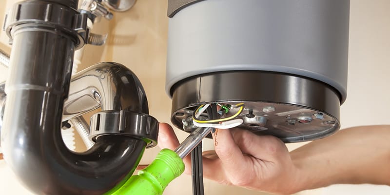 Technician repairing the heating element of a water heater in La Quinta