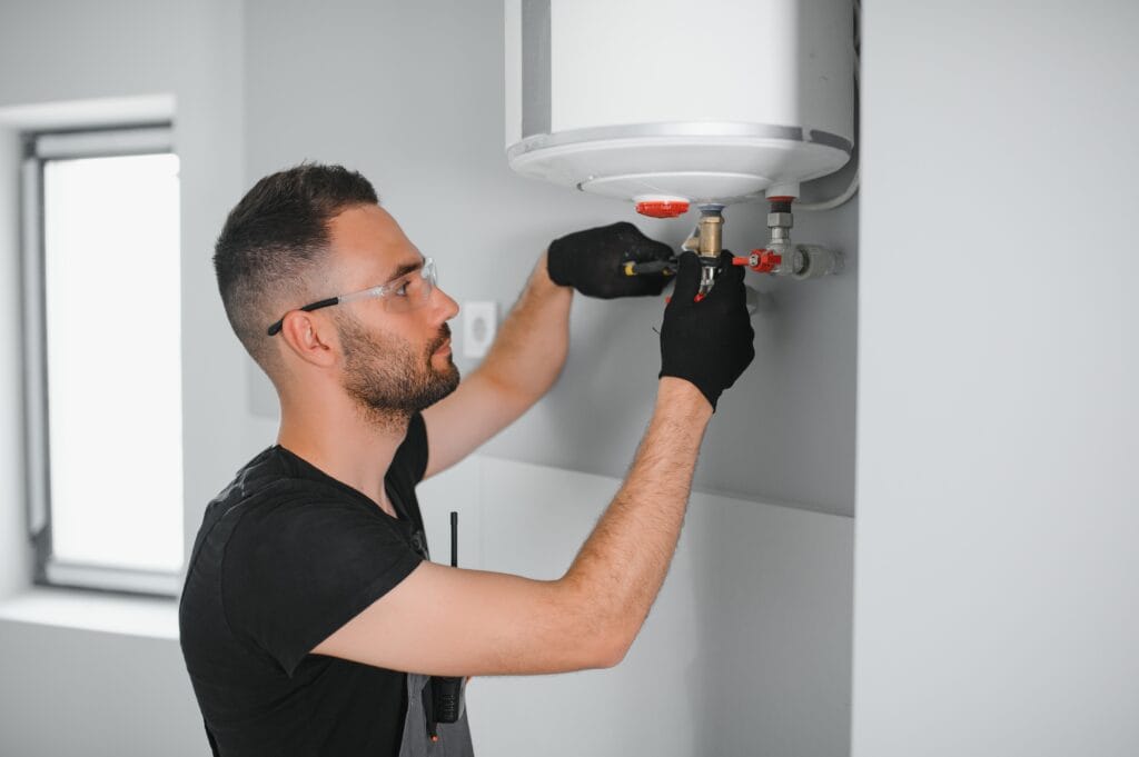 Technician performing water heater maintenance in La Quinta